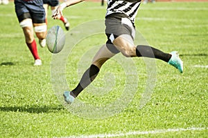 Rugby player kicking the ball