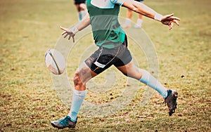 rugby player preparing to kick the oval ball during game
