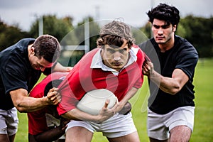 Rugby players tackling during game