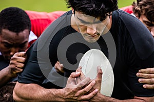 Rugby players tackling during game