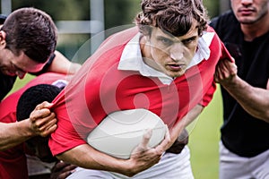 Rugby players tackling during game