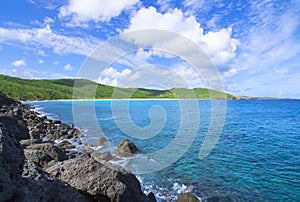 Rugged Caribbean coastline and rolling green hills photo