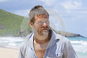 Rugged castaway man on deserted island photo