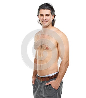 Rugged and charming. Studio portrait of a handsome, shirtless man posing against a white background.