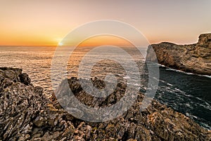 Rugged cliffs of the coastline of Cape St. Vincent at sunset. Near Lagos, Algarve region of Portugal.