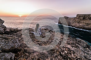 Rugged cliffs of the coastline of Cape St. Vincent at sunset. Near Lagos, Algarve region of Portugal.