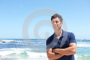 Rugged middle aged man standing at the beach