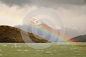 Rugged mountains and a rainbow on Seno de Ultima Esperanza, Patagonia, Chile