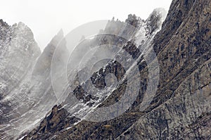 Rugged mountains in the winter fog photo