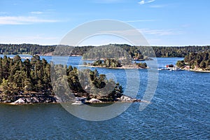 Rugged nature with wooded islands and rocky cliffs in Stockholm archipelago. Uninhabited islets, communities and ancient villages