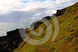 Rugged seaside green hill with path at Port Macquarie Australia