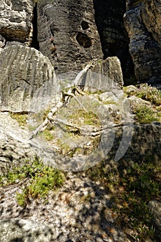 Rugged sloping terrain leading to taller rock formations