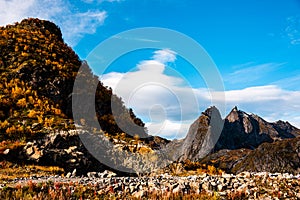 Rugged, stony and rocky mountain landscape in the Lofoten Islands in Norway - the mountain peaks are illuminated