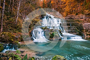 Rugged Waterfalls and River in Forest with Autumn Foliage