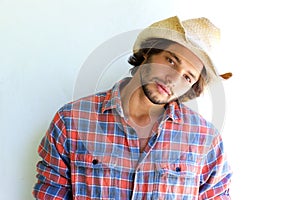 Rugged young man with plaid shirt and cowboy hat photo