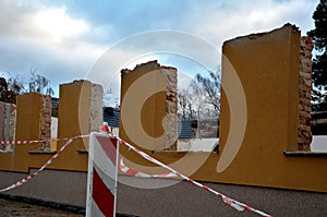 Ruin of a family house behind a plastic security tape barrier. the statically disturbed building is being demolished. reconstructi photo