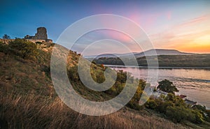 Ruin on a Hill over a River at Sunset