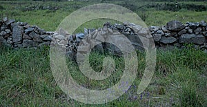 Ruin of old stone wall in rural Portugal. Straight view.