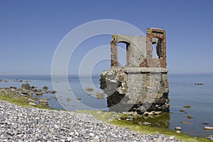 Ruin at rocky coastline