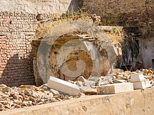 Ruin structure, debris scattered scene in rural village in India. Wreckages of building