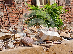 Ruin structure, debris scattered scene in rural village in India. Wreckages of building