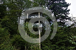 Ruin of a tower made of concrete with guardrail spotted in the forest in the Vosges