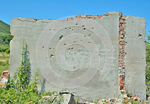 Ruin of wall with bullet-holes photo