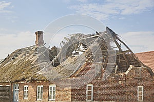 Ruined abandoned house with thatched roof in Denmark