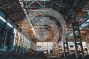 Ruined and abandoned industrial factory warehouse hangar with perspective view