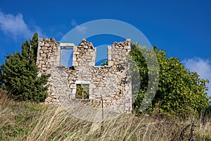 Ruined abandoned stonewall house rural environment nature sunny day blue sky Peloponnese Greece