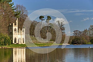 Ruined abbey, beside lake at Painshill park, Cobham, Surrey.