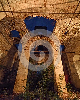 Ruined ancient church with columns and hole in roof where starry