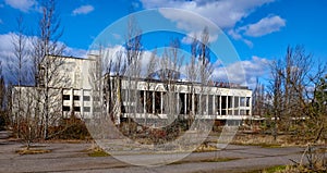 Ruined architecture, windows shattered, standing amidst untamed nature. The Energetik Palace of Culture is a now abandoned