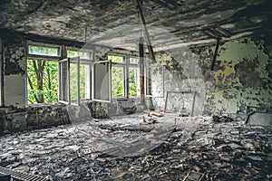 Ruined assembly hall with debris in abandoned Pripyat school