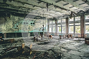 Ruined assembly hall with debris in abandoned Pripyat school