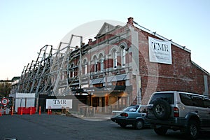 Debris of partially damaged old historic architecture supported by steel frame seismic bracing in Christchurch, New Zealand