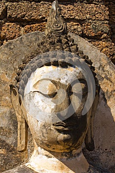 Ruined Buddha's hade in Wat Phra Si Ratana Mahaphat, Si Satchanalai, Thailand