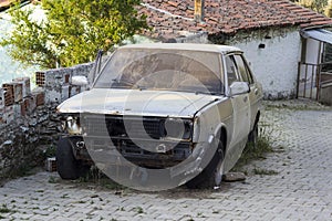 Ruined car next to paved road