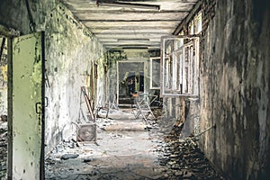 Ruined class room with desks and blackboards in Pripyat school