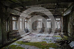 Ruined creepy room covered in moss at the abandoned building located in the Chernobyl ghost town