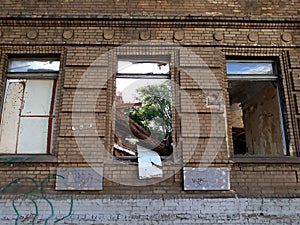 The ruined facade of an old brick building