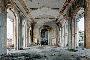 Ruined large hall interior overgrown by plants and moss