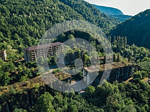 Ruined lost overgrown mining ghost town Akarmara, consequences of war in Abkhazia, aerial view from drone