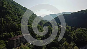 Ruined lost overgrown mining ghost town Akarmara, consequences of war in Abkhazia, aerial view from drone