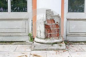 Ruined lower part of the pilaster, with fallen plaster and exposed brickwork