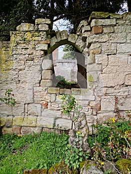 Ruined medieval priory wall and window
