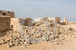 Ruined old Arab pearling and fishing town Al Jumail, Qatar. Pile of stones. The desert at coast of Persian Gulf.