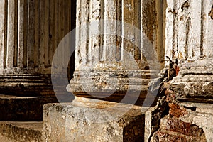 Ruined old columns with base and flute. Sunlight