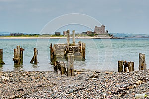 Ruined pier, beach and castle