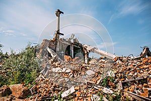 Ruined red brick building destroyed by earthquake or tornado or war or other disaster. Demolished house. Debris, garbage